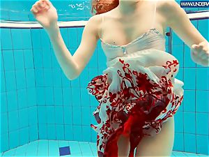 torrid grind redhead swimming in the pool